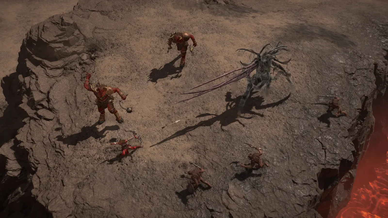 Vários personagens cercam um inimigo alado em uma plataforma de rocha sobre lava